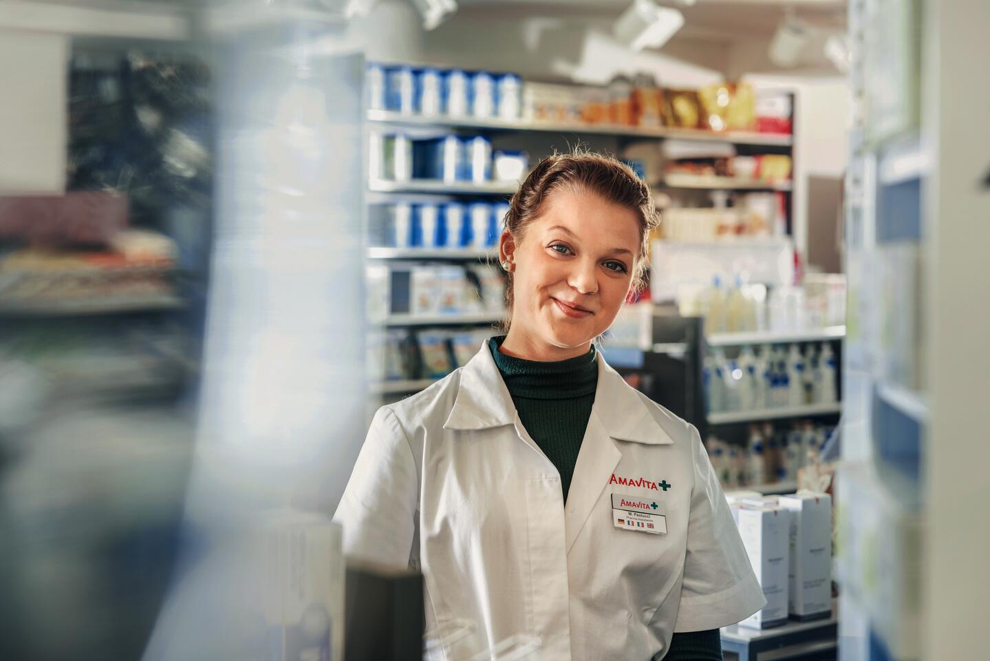 A pharmaceutical assistant smiles 