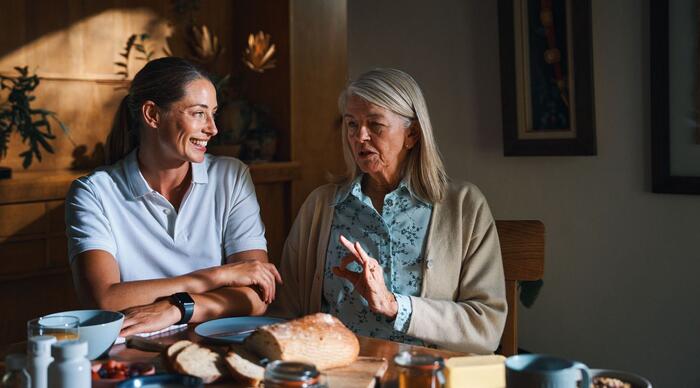 Une image d’une infirmière avec sa cliente, toutes deux en train de rire.