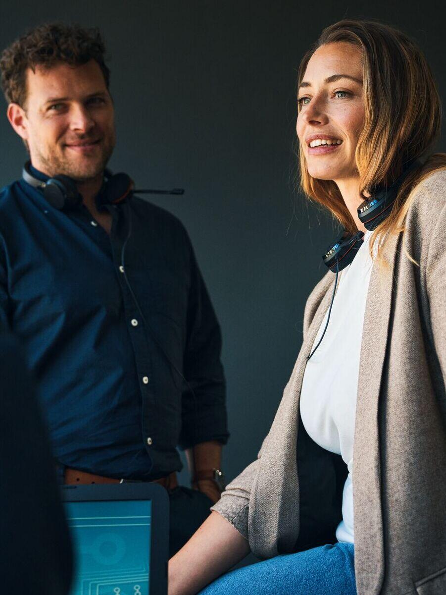 Two pharmacists stand back to back